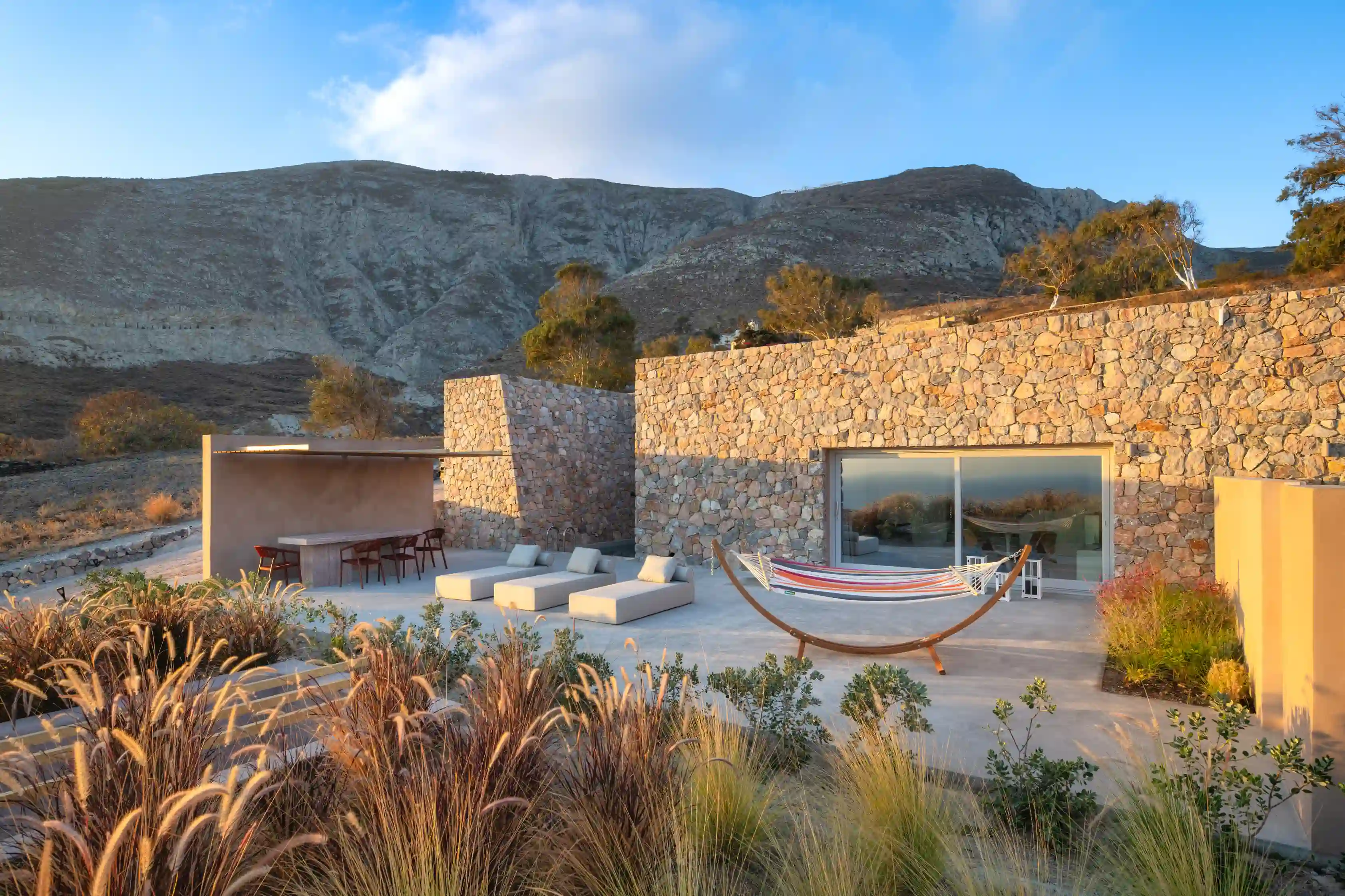 Felicity Cave Villas Deluxe Gaia - Stone-built hillside luxury villa exterior with panoramic Santorini landscape views