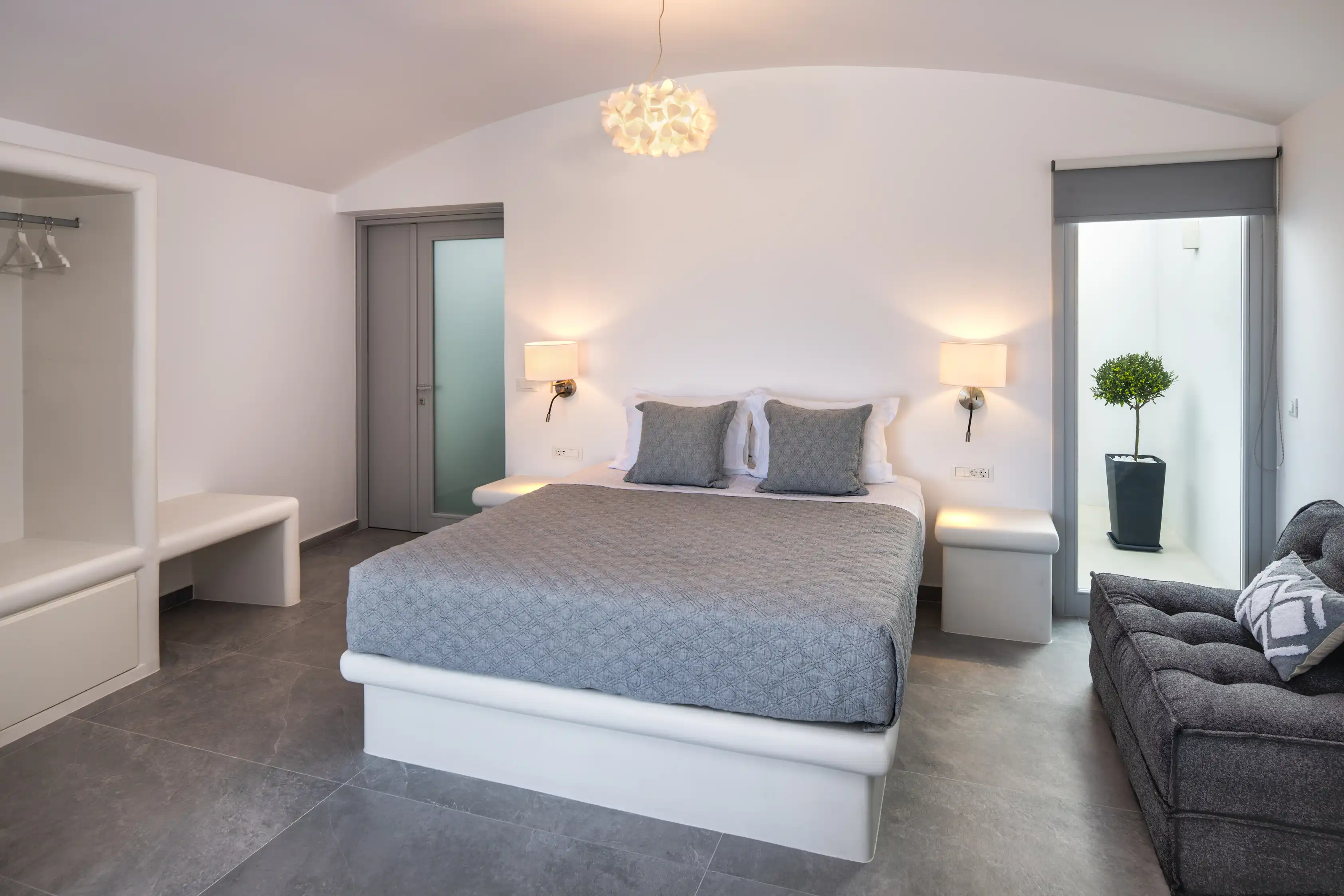 Deluxe Gaia Cave Villa cozy bedroom atrium - Intimate sleeping space with natural stone walls