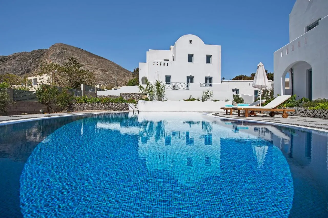 Felicity Villas Kamari daytime view - Shared swimming pool with mountain backdrop and coastal village setting