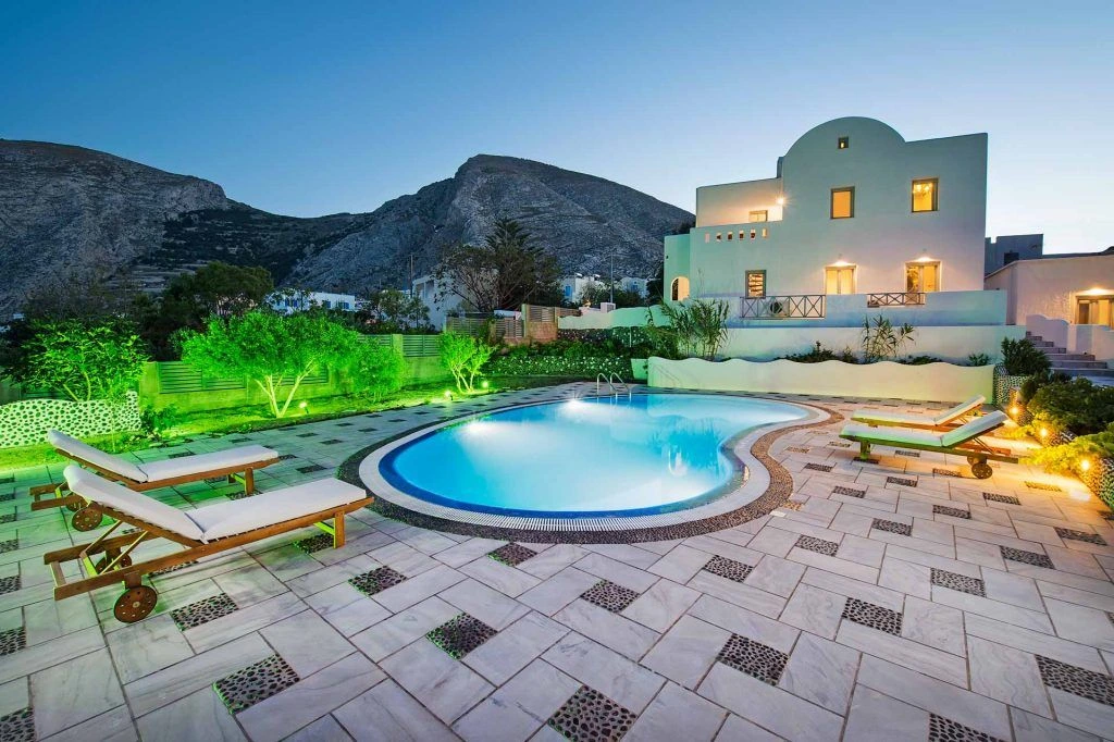 Villa Victoria — exterior swimming pool with mountain backdrop at night